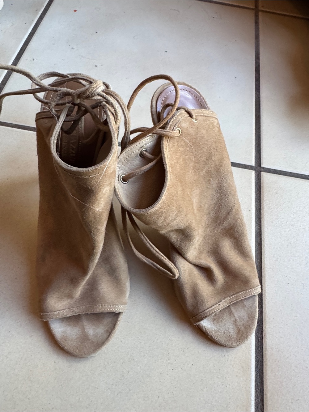 Aquazzura Mayfair suede lace-up peep toe booties in a natural tan color.